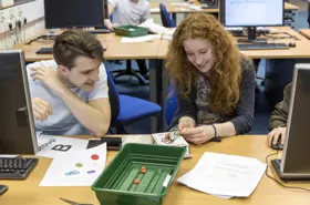 Students at computer desk working on project together