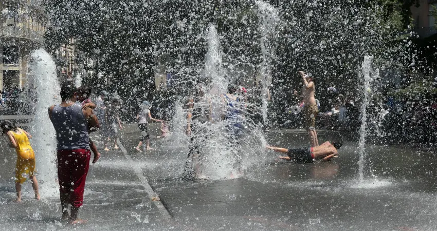Children play in water park during heatwave